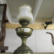 A brass oil lamp complete with shade and chimney,.