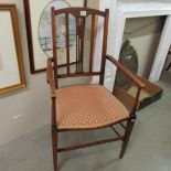 A mahogany inlaid elbow chair.