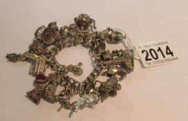 A silver charm bracelet with approximately 24 charms.