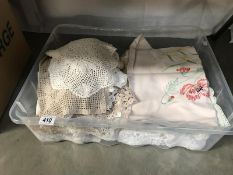 A box of linen including quantity of crocheted doilies etc.
