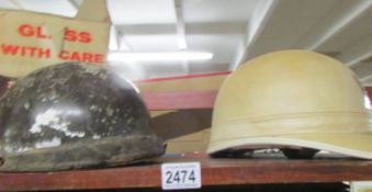 2 vintage motorcycle helmets.
