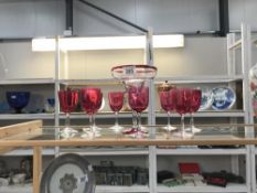 A quantity of cranberry glasses and 1 other item