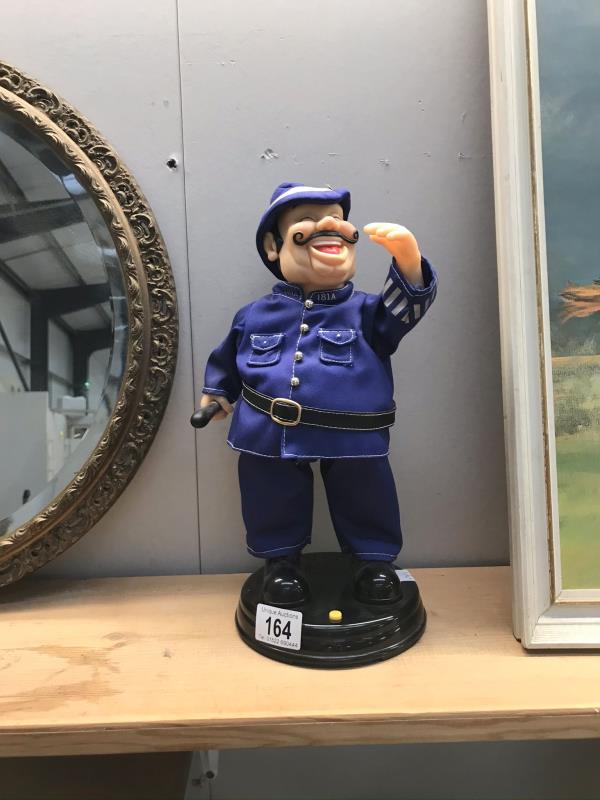 A laughing policeman musical figurine