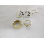 A 9ct gold wedding ring, size M and another 9ct gold ring, size K.