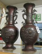 A pair of 19th century oriental bronze dragon vases.