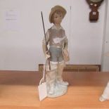 A Lladro fisher boy figure.