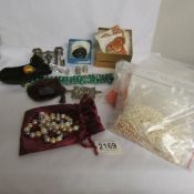 A mixed lot including costume jewellery, necklaces, enamel vinaigrette, enamel buckle, glass seal,
