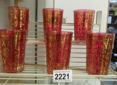 A set of 6 gold decorated cranberry glass tumblers.