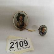 A porcelain brooch depicting a portrait of a 17/18th century boy in a 9ct gold mount together with