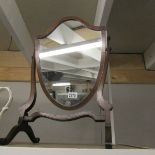 A Victorian mahogany shield shaped mirror.