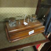 An oak inkstand with glass inkwells.