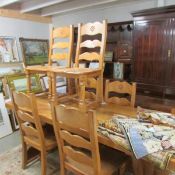 A heavy light oak dining table and 6 chairs.