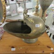 A brass 'helmet' coal scuttle with coal scoop.