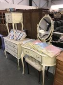 A white ormalu bedroom set consisting of dressing table, mirror, 3 drawer chest,