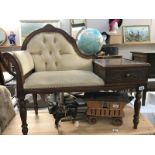 A dark wood stained deep buttoned reading table