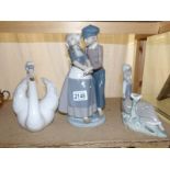 A Lladro swan, a Lladro Dutch boy and girl together with a Lladro girl sitting with dove.