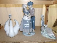 A Lladro swan, a Lladro Dutch boy and girl together with a Lladro girl sitting with dove.