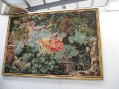 A large gilt framed tapestry