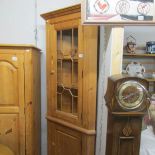 A pine corner cabinet.