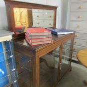 A mahogany display cabinet with mirror to back.