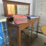 A mahogany display cabinet with mirror to back.