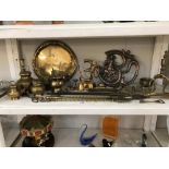 A shelf of brass items etc.