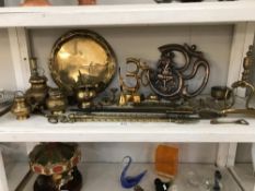 A shelf of brass items etc.