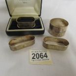 A cased silver napkin ring, a pair of silver napkin rings and a Scottish silver napkin ring,