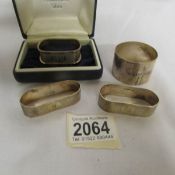 A cased silver napkin ring, a pair of silver napkin rings and a Scottish silver napkin ring,