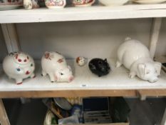 A shelf of piggy banks/money banks