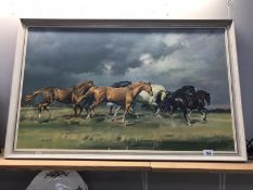 A framed galloping horses picture