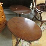 A pair of oval occasional table with claw feet.