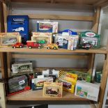 2 shelves of boxed die cast vehicles.