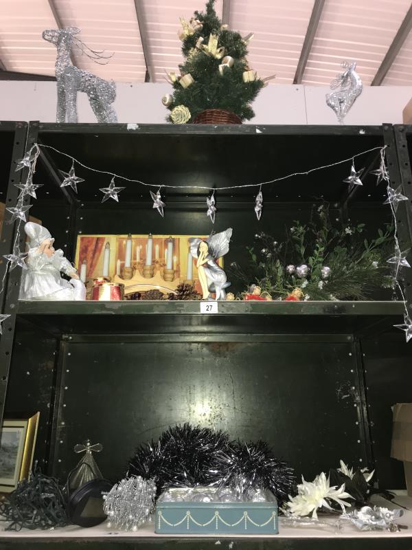 3 shelves of Christmas decorations