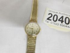 An Omega ladies wrist watch in 9ct gold, in working order, approximate total weight 17.7 grams.