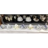 2 shelves of crockery including cups/saucers and trios and Royal Albert dish