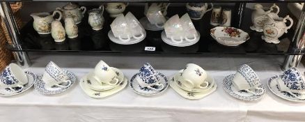 2 shelves of crockery including cups/saucers and trios and Royal Albert dish