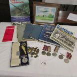 An interesting lot of military items including medals, books, framed and glazed print etc.