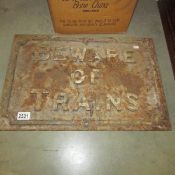A cast iron railway warning sign 'Beware of Trains'.