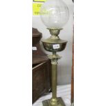 A brass Corinthian column oil lamp with etched glass shade.