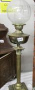 A brass Corinthian column oil lamp with etched glass shade.