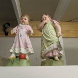 A pair of continental bisque porcelain figures of children (1 a/f, missing fingers).