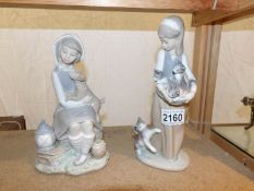 2 Lladro figurines being a girl with cats and a girl with dogs.