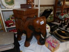 A carved wood elephant stool/plant stand.