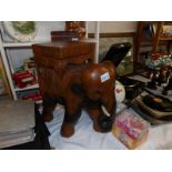 A carved wood elephant stool/plant stand.