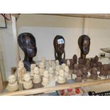 A set of Thorn carving chess pieces, a pair of Yoruba carved busts and a West African carved bust.