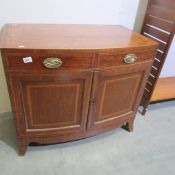 A mahogany inlaid cabinet.