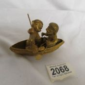 A Pre-Columbian art object of 2 figures in a canoe (possibly Tumbaga).