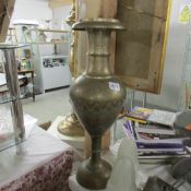 A tall Asian brass vase.