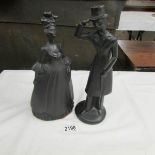 A pair of Royal Wessex black silhouette figures of a lady and gentleman.